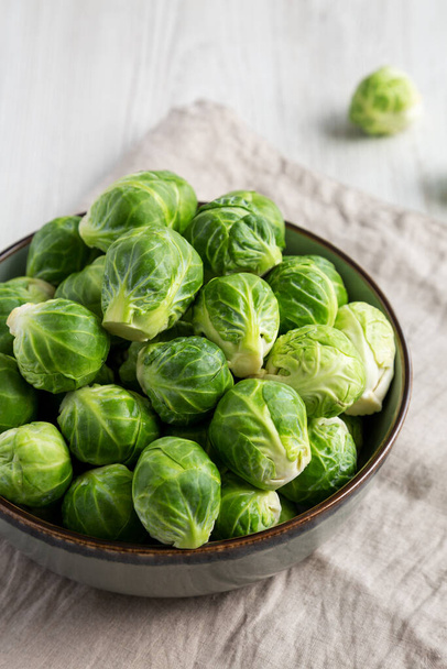 Raw Organic Brussel Sprouts in a Bowl, side view.  - Fotó, kép