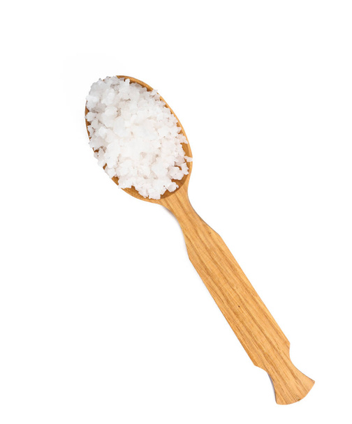 grandes cristales de sal marina blanca en una cuchara de madera marrón, vista superior - Foto, Imagen