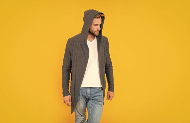 guy with bristle wear hood on yellow background, lifestyle. - Foto, Imagen