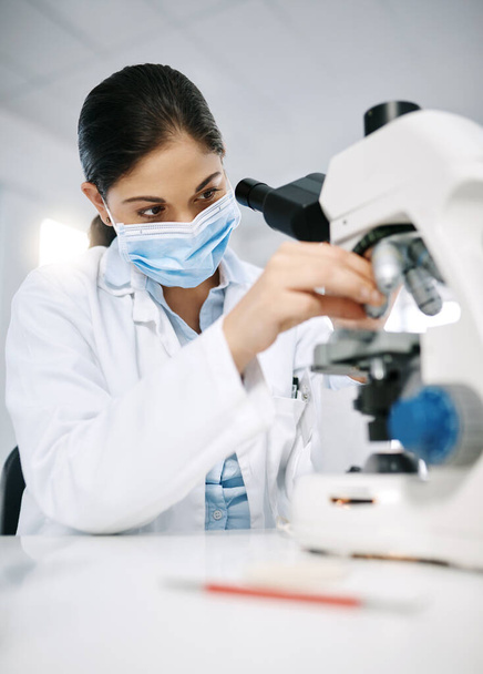 Every sample is vital to her study. a young scientist using a microscope in a lab - Photo, image