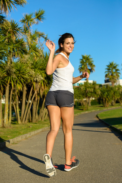 Female athlete running and waving - Foto, Imagem