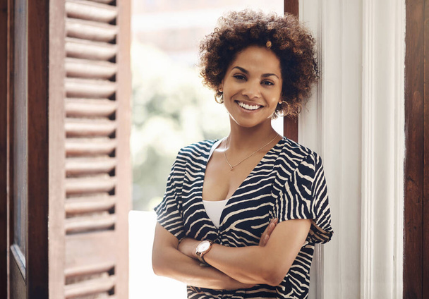 Smiling real estate agent looking motivated, ambitious and confident with arms crossed in new listing, rental or property. Portrait of afro woman ready to sell new house, negotiate a loan or mortgage. - Foto, Imagem
