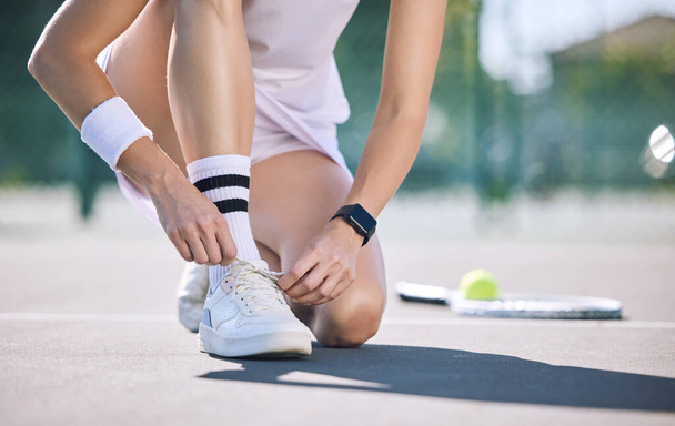 Female tennis player foot and hands tying shoelaces before game match on outdoor sports court. Active, sporty woman preparing for training for fun, summer exercise and healthy, wellness lifestyle - Zdjęcie, obraz