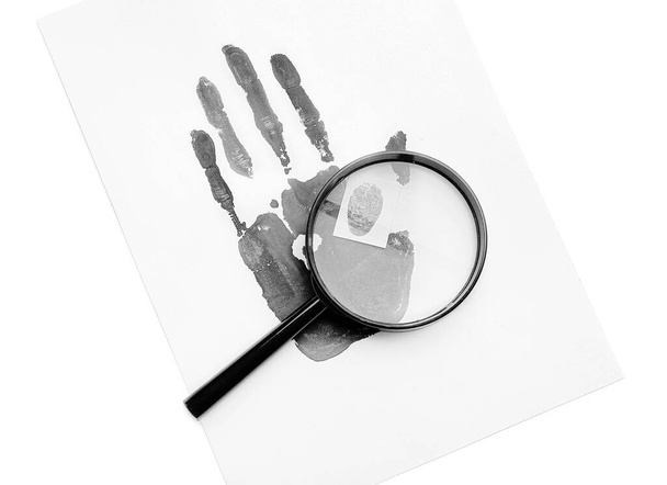 Magnifier and paper sheet with palm and finger prints on white background - 写真・画像