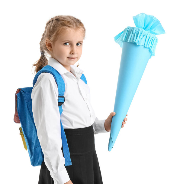 Cute little girl with blue school cone and backpack on white background - Foto, Bild