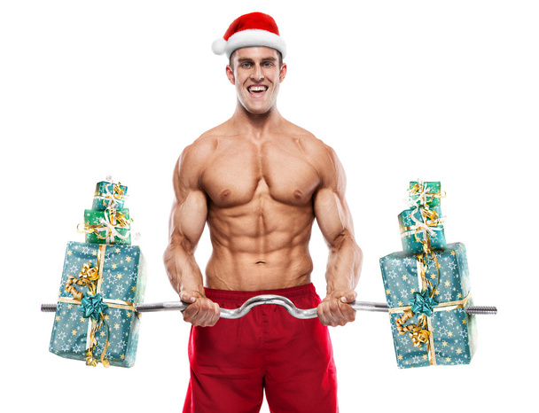 Muscular Papai Noel fazendo exercícios com presentes sobre backg branco
 - Foto, Imagem