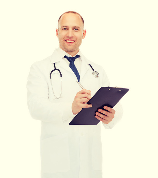 smiling male doctor with clipboard and stethoscope - Zdjęcie, obraz