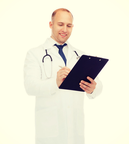 smiling male doctor with clipboard and stethoscope - Φωτογραφία, εικόνα