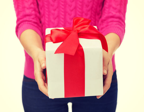 close up of woman in pink sweater holding gift box - Foto, immagini