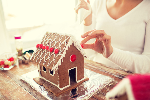close up of woman making gingerbread houses - Fotoğraf, Görsel