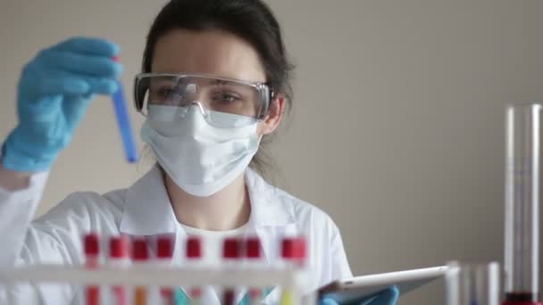 Laboratory Assistant with Test-tubes and Tablet - Záběry, video