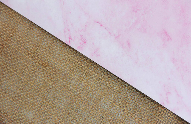 brown canvas fabric and marble pink background, divided diagonally - Fotografie, Obrázek