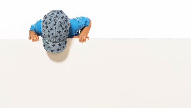  little boy is above on the empty white placard. isolated on whi - 写真・画像