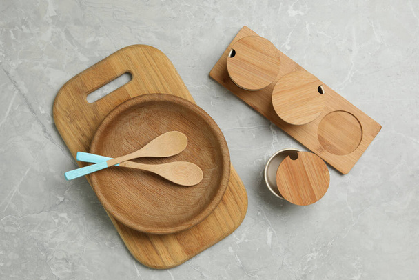 Wooden cooking utensils on grey marble table, flat lay - Fotografie, Obrázek