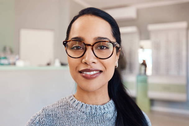 New glasses at optometrist checkup, buying eyewear and fitting frames at a shop. Closeup portrait of the face of female doing eyecare, examining eyesight and standing at optician consultation. - Fotoğraf, Görsel