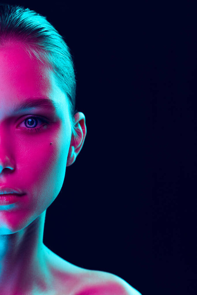 Blue eyes. Close up eyes of beautiful young girl looking camera in pink neon light. Concept of cosmetics, makeup, natural and eco treatment, skin care. Shiny and healthy look, fashion, vision. Details - Zdjęcie, obraz
