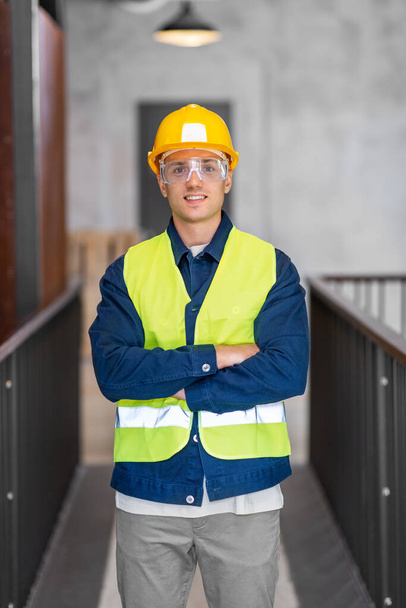 architecture, construction business and building concept - happy smiling male architect in helmet, goggles and safety west at office - Zdjęcie, obraz