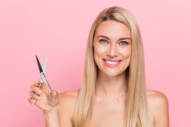 Photo of joyful lady hold scissors prepare party beauty hairstylist salon isolated over pastel pink color background. - Foto, imagen