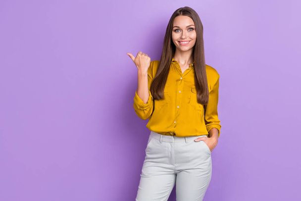 Photo of optimistic brown hair lady index promo wear brown shirt trousers isolated on purple color background. - Photo, image