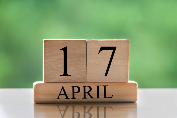 April 17 calendar date text on wooden blocks with blurred park background. Copy space and calendar concept. - Fotoğraf, Görsel