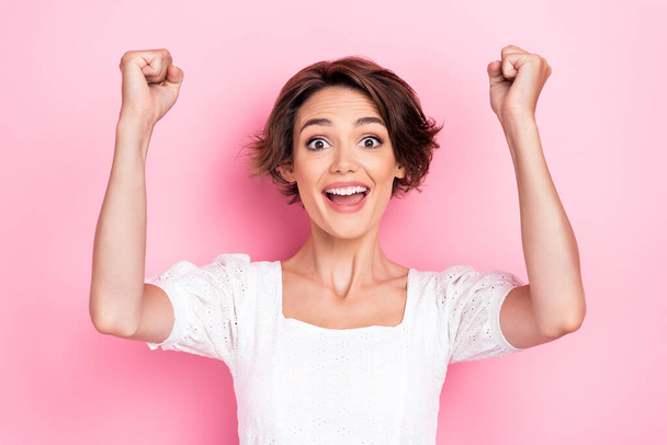 Photo portrait of stunning young lady support favorite team raise fist excited dressed trendy white look isolated on pink color background. - Φωτογραφία, εικόνα
