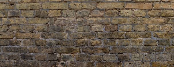 Wide weathered beige brown brick wall background - Photo, image