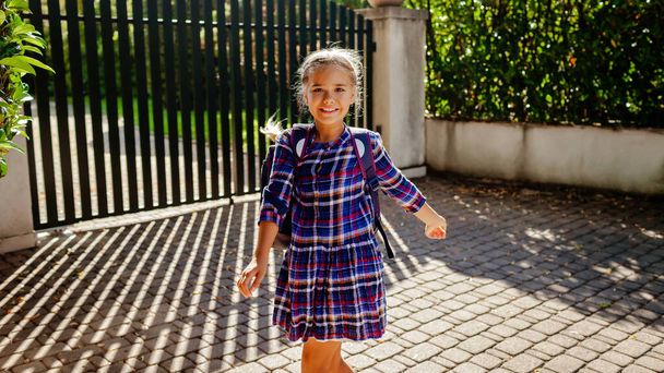 Back to school. Happy girl with backpack, teenager school kid, runs to school from the home at the first day, study and education, return after vacations, lifestyle. Banner format - Fotó, kép