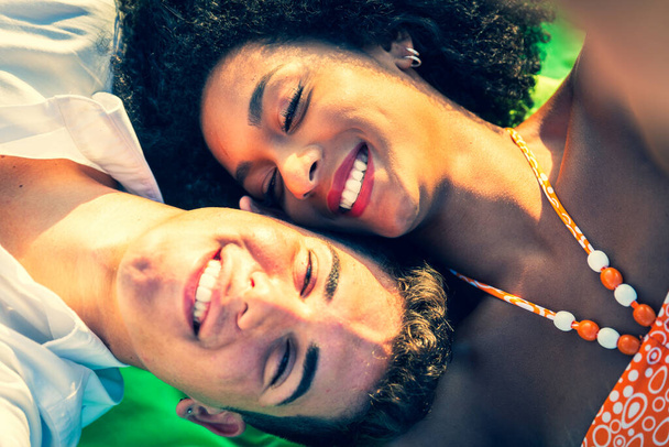Multiracial couple cheek-to-cheek in intimate portrait   interracial young couple relaxing cheek to cheek  multicultural people portrait   - Foto, imagen