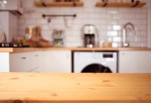 empty wooden tabletop and blurred kitchen mock up for product display - Foto, Imagen