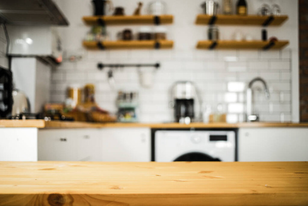 empty wooden tabletop and blurred kitchen mock up for product display - Valokuva, kuva