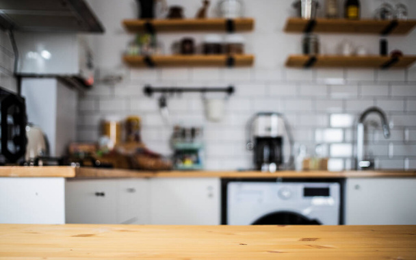 empty wooden tabletop and blurred kitchen mock up for product display - Foto, Imagen