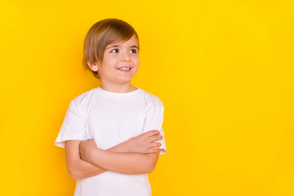 Portrait of attractive minded genius cheerful pre-teen boy folded arms thinking copy space isolated over bright yellow color background. - Foto, afbeelding