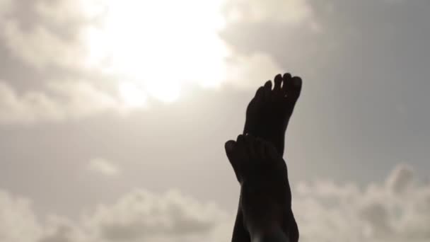 Точка зрения женщина, играющая с красивыми татуированными ногами, пересекающая солнце.. - Кадры, видео