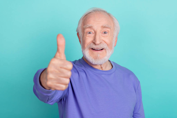 Photo of satisfied cheerful aged man arm finger demonstrate thumb up rate quality isolated on teal color background. - Фото, зображення