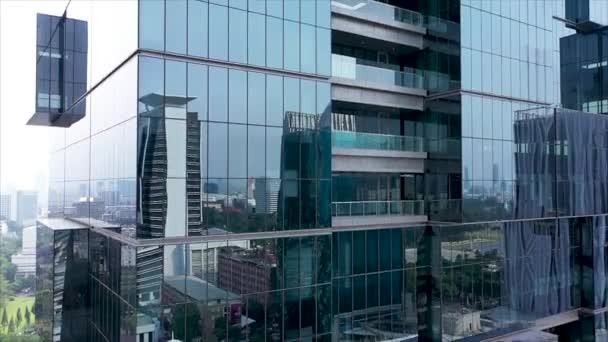 Close up bank building in Jakarta a Futuristic and modern design skyscraper. - Felvétel, videó