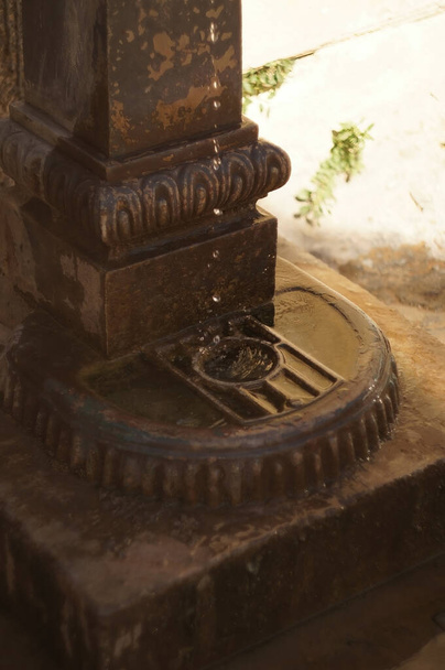 steel fountain, dripping water, drinking fountain, forged steel, patina on aged materials, indirect light, mexico, latin america, without people - Valokuva, kuva