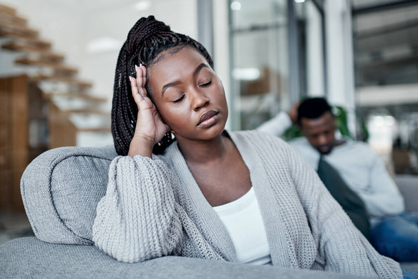 Sad, frustrated and tired woman ignoring husband during a fight, argument and conflict about divorce, breakup and relationship problems. Unhappy, stressed and depressed wife feeling sad in a marriage. - Fotó, kép
