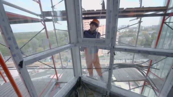 Worker sets window in room - Кадри, відео