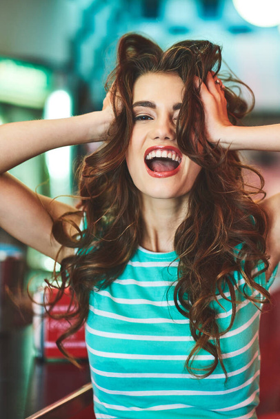 Lets get crazy, its weekend. a beautiful young woman in a diner - Foto, Imagen