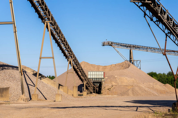 Panoramic view heavy metal construction open pit gravel plant sand quarry big rusty rotor machine material excavating and crushing on blue sky. Industrial machinery factory equipment steel background. - Photo, image