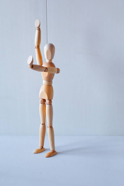 Concept of making the stop signal with the figure of a wooden boy - Fotoğraf, Görsel