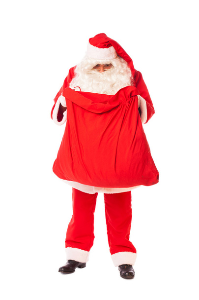 Santa claus holding his sack of gifts on white background - Foto, Imagem