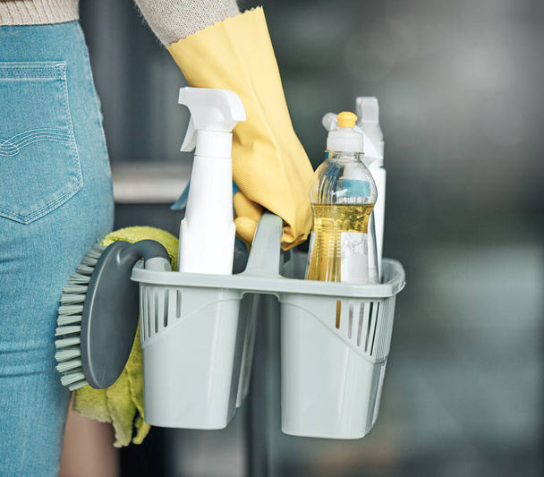 Domestic worker, maid or cleaner hands holding or carrying cleaning products and equipment or supplies. For home hygiene, contact us for a handy helper agency or professional household service - Foto, afbeelding