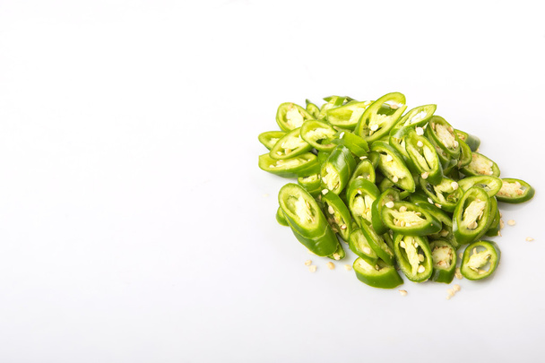 Chopped green chili peppers over white background - Foto, Imagem