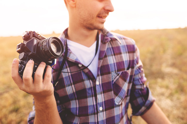 Hombre joven con cámara de fotos retro hipster al aire libre Estilo de vida
 - Foto, Imagen