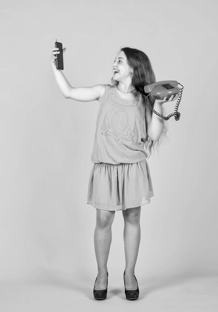 pretty teen girl with retro and modern phone, technology. - Φωτογραφία, εικόνα
