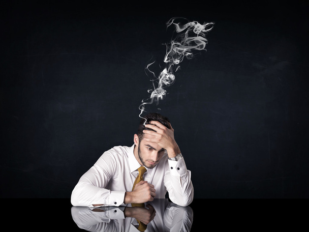 Depressed businessman with smoking head - Foto, Bild