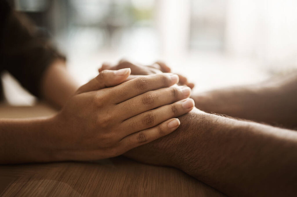 Just keep holding on. two unrecognizable people holding hands in comfort - 写真・画像
