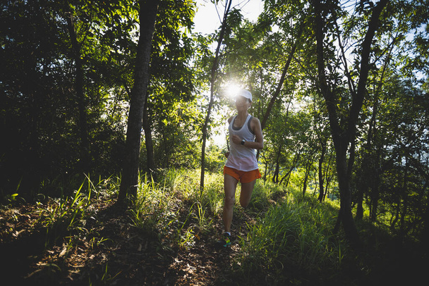 Woman runner running on forest trail - Foto, Imagen