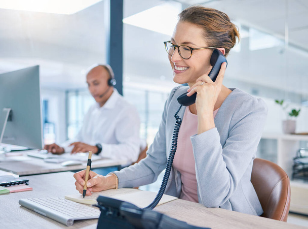 Call center operator, marketing agent and sales consultant networking, talking and consulting on telephone. Friendly secretary, business woman and support helpdesk writing notes for customer service. - Φωτογραφία, εικόνα
